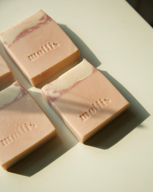 Handmade soap with rose geranium and honeysuckle essential oils, enriched with Moroccan red clay for gentle exfoliation