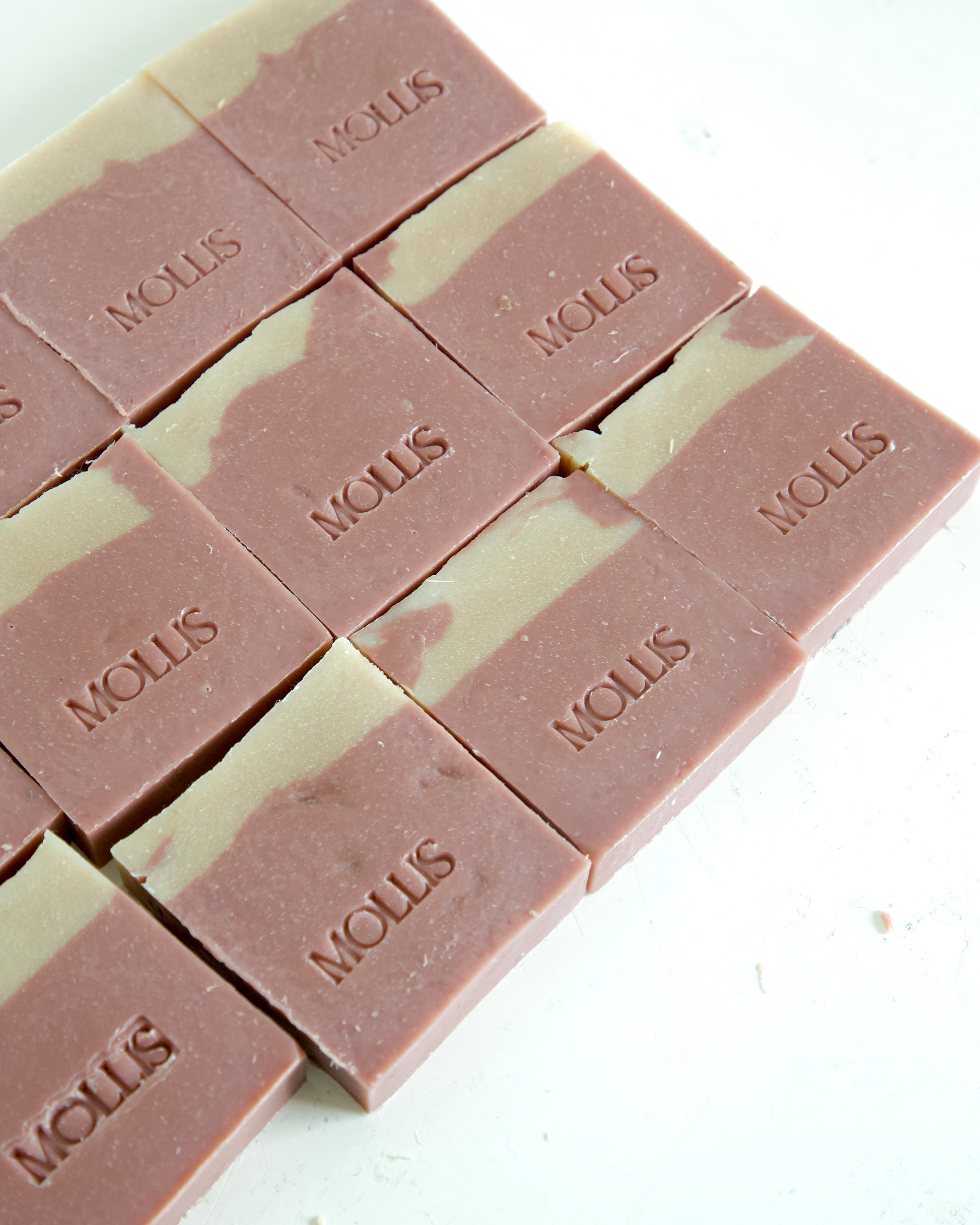 HANDMADE SOAPS LAID OUT ON A TABLE VEGAN ROSE SOAP